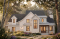 front - BASE MODEL - Two-story English Tudor-inspired house plan with double garage and up to 5 bedrooms. - Eugene