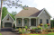 front - BASE MODEL - Two-bedroom house plan with nice front porch, fireplace, lots of natural light in kitchen, garage included - Lowrey