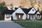 front - BASE MODEL - Multi generational Farmhouse house plan with garage, great open concept on both unit, covered patio & balcony - Generation