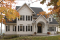 Color version 1 - Front - Big family house plan with 3-car garage, 4 bedrooms, main floor master suite, guest suite, formal dining - Abraham